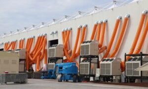 Modern industrial cooling units with striking orange ducts outside a building. - Photo by Oguz Dik on Pexels