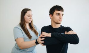A physiotherapist assists a patient with arm exercises in a clinical setting. - Photo by Funkcinės Terapijos Centras on Pexels