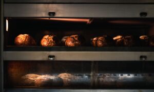 Warm artisan bread being baked to perfection in a professional industrial oven. - Photo by Chris F on Pexels