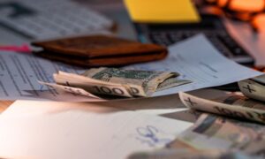 Zloty banknotes and financial paperwork scattered on a desk, representing budgeting and finance. - Photo by Jakub Zerdzicki on Pexels