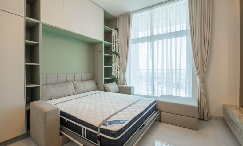 Stylish bedroom featuring a pull-down Murphy bed, elegant curtains, and bright lighting. - Photo by Waqas ilyas on Pexels